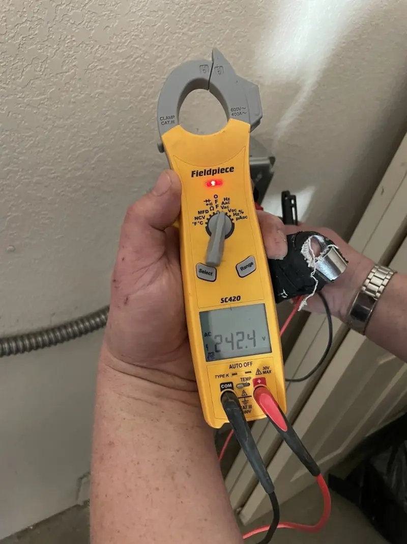 Voltage testing with clamp meter during Ceiling Fan Installation in Eagleton Village